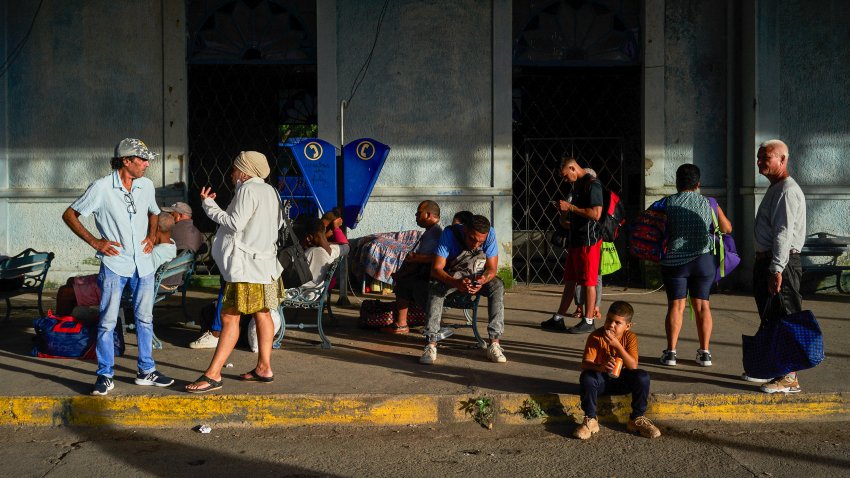 People wait for transportation at a bus station in Matanzas, Cuba, on October 18, 2024, during a nationwide blackout caused by a grid failure. Technical breakdowns, fuel shortages and high demand have caused the country’s thermoelectric power plants to constantly fail, forcing the government to declare an energy emergency and take measures such as closing schools and factories.