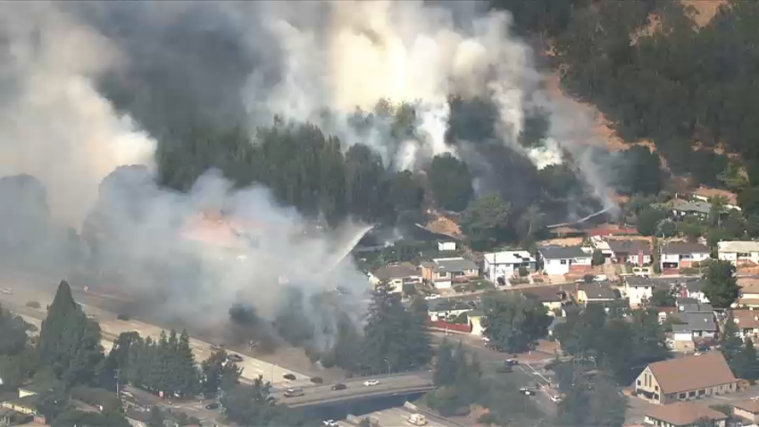 A fire burns near Interstate 580 in Oakland.