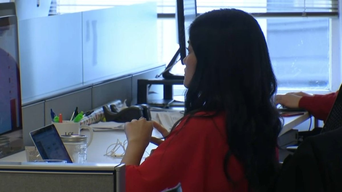 Latina workers protesting for equal pay at a corporate event