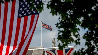 The U.S. Stars and Stripes flag hangs on Whitehall with the figure of Lord Nelson on the top of his column in Trafalgar Square, on 3rd June 2019, in London England. 