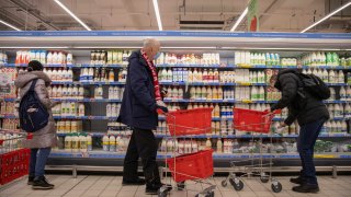 Customers shop for milk and dairy items inside an Auchan Retail International hypermarket in Moscow, Russia.