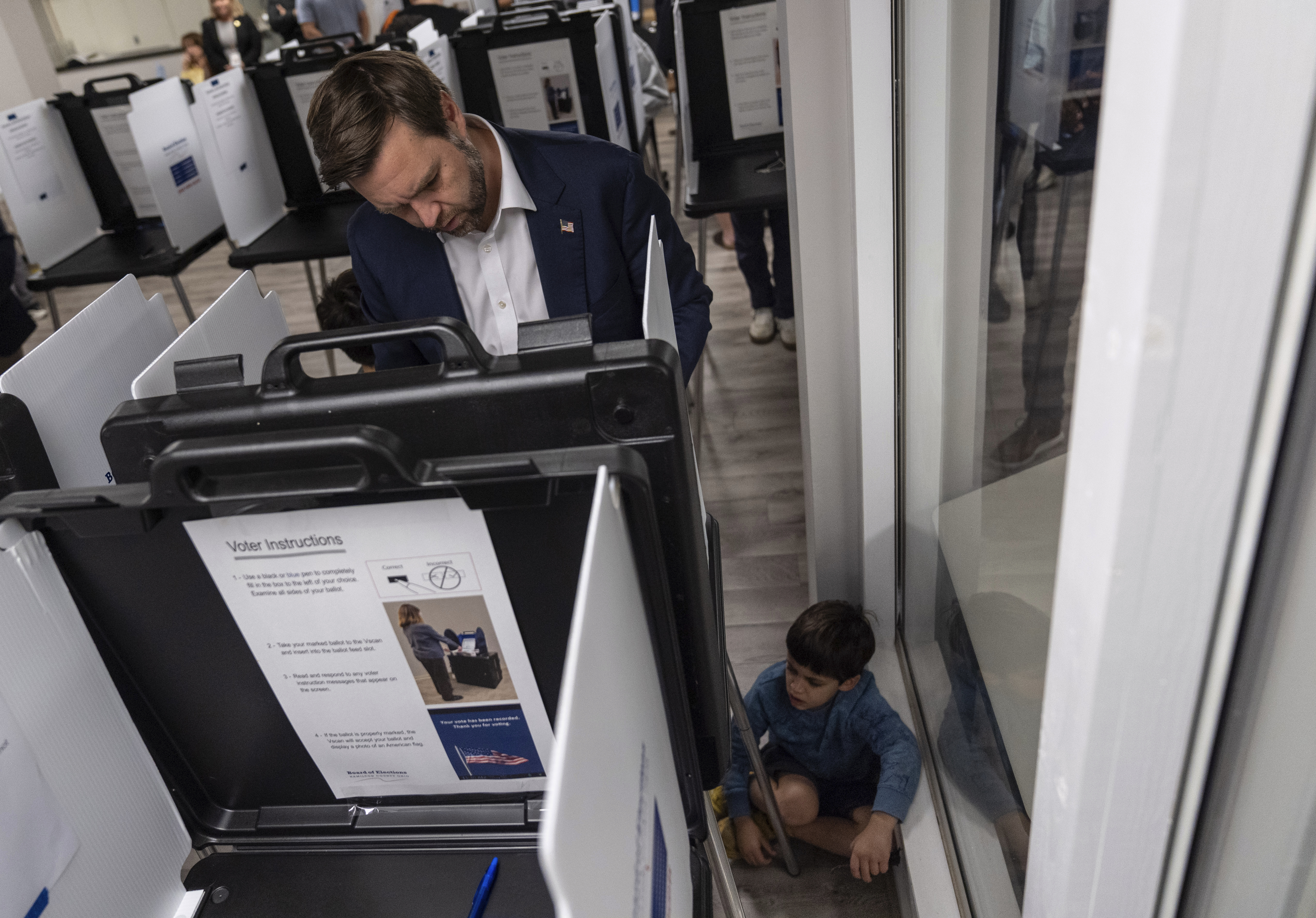 Republican vice presidential nominee Sen. JD Vance, R-Ohio, votes with his son at the St Anthony of Padua Maronite Catholic Church on election day, Tuesday, Nov. 5, 2024, in Cincinnati.