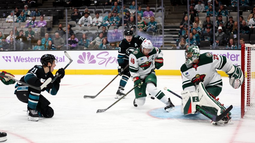 Macklin Celebrini #71 of the San Jose Sharks scores on Marc-Andre Fleury #29 of the Minnesota Wild.