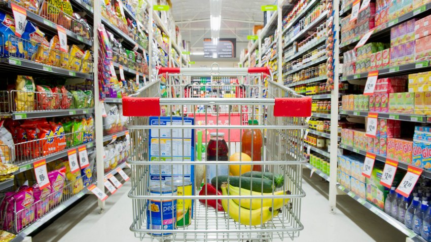 Shopping cart in grocery store aisle