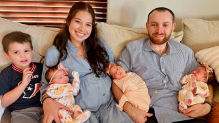 Marisa Christie and her husband with their son and triplet daughters, Charlotte, Kendall and Collins