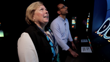 Margaret Spring, who oversees conservation efforts and research at the Monterey Bay Aquarium, shows off the aquarium's massive arcade game, designed to explain how easy it is for sea creatures to confuse tiny plastics for food.