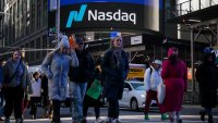 Pedestrians pass the Nasdaq MarketSite in New York, US, on Tuesday, Jan. 2, 2024.