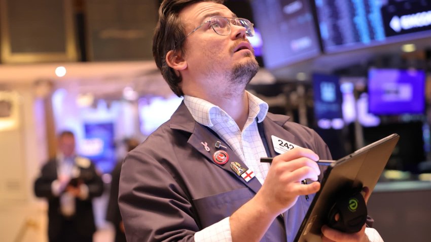 Traders work on the floor of the New York Stock Exchange during morning trading on Nov. 26, 2024.