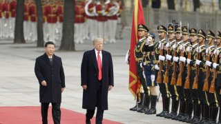 U.S. President Donald Trump, right, and Xi Jinping, China’s president, walk past members of the People’s Liberation Army (PLA) during a welcome ceremony outside the Great Hall of the People in Beijing, China, on Thursday, Nov. 9, 2017.  