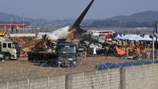 Firefighters and rescue personnel work near the wreckage of a Jeju Air Boeing 737-800 series aircraft after the plane crashed and burst into flames at Muan International Airport in South Jeolla Province, some 288 kilometres southwest of Seoul on Dec. 29, 2024.