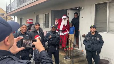 Oakland police officers hand out gifts, holiday dinners to families in need