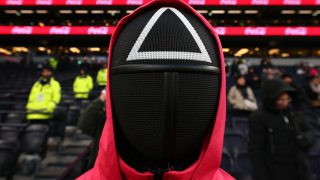 File. Squid games is advertised pitch side with actors dressed up during the Premier League match between Tottenham Hotspur FC and Liverpool FC at Tottenham Hotspur Stadium on December 22, 2024 in London, England.