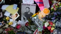 FILE - A picture of former One Direction singer Liam Payne sits surrounded by flowers and candles as fans gather outside the hotel where he was found dead after falling from a balcony in Buenos Aires, Argentina, Oct. 17, 2024.