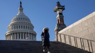 A woman walks down the stairs in front of the U.S. Capitol building, ahead of the presidential inauguration of Donald Trump, in Washington on Jan. 15, 2025.