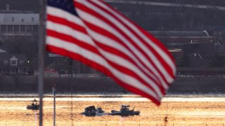Rescuers on boats work as the sun rises at the site of the crash in the Potomac River after a Black Hawk helicopter and an American Eagle flight 5342 approaching Reagan Washington National Airport collided and crashed outside Washington, U.S., January 30, 2025.Â