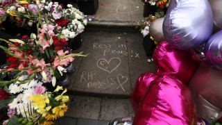Tributes are seen outside the Town Hall in Southport, England