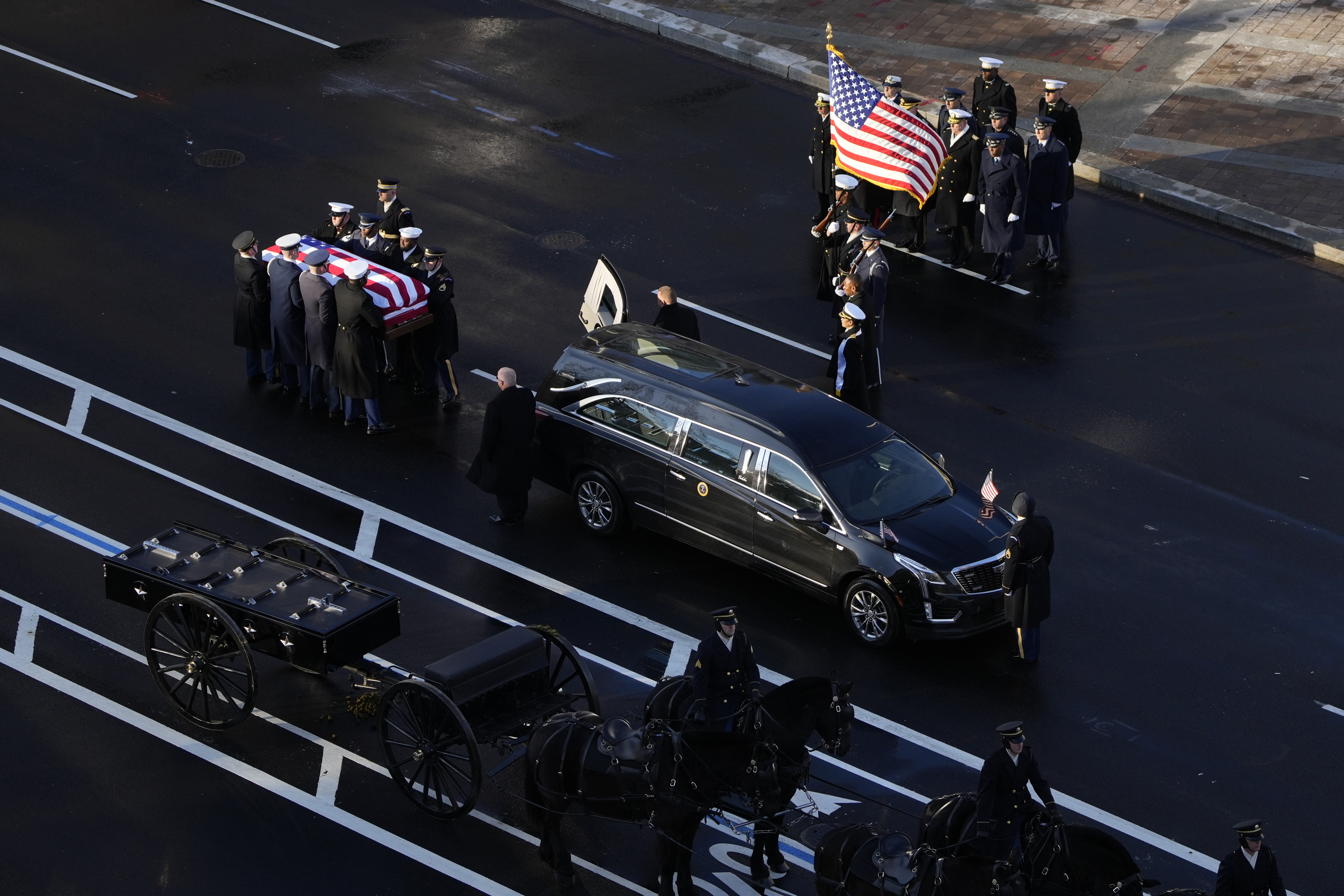 Carter’s casket is transferred to a horse-drawn caisson at the U.S. Navy Memorial before traveling on to the Capitol.