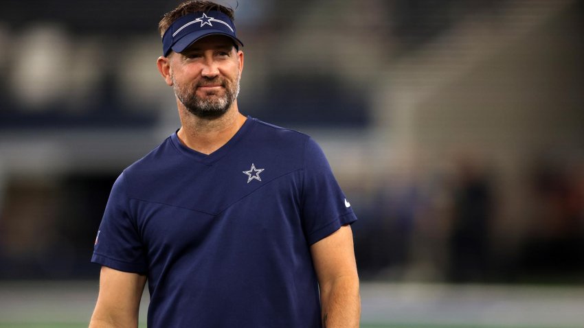 Aug 26, 2023; Arlington, Texas, USA; Dallas Cowboys offensive coordinator Brian Schottenheimer on the field before the game against the Las Vegas Raiders at AT&T Stadium.