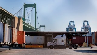 A truck drives past shipping containers at the Port of Philadelphia, Nov. 6, 2024.