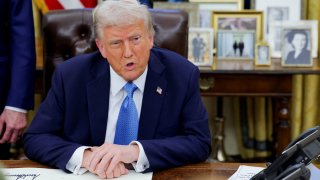 U.S. President Donald Trump looks on as he signs an executive order in the Oval Office at the White House in Washington, U.S., Jan. 31, 2025. 