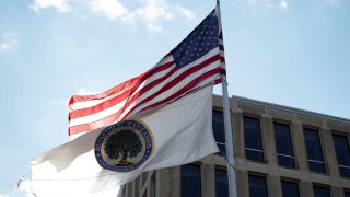 An American flag and a U.S. Department of Education flag fly outside the US Department of Education building in Washington, D.C., U.S., Feb. 1, 2025. 