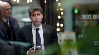 Sam Altman, CEO of OpenAI, at Station F, is seen through glass, during an event on the sidelines of the Artificial Intelligence Action Summit in Paris, France, Feb. 11, 2025. 