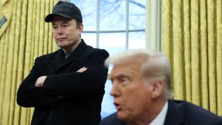 Elon Musk listens to U.S. President Donald Trump speak in the Oval Office of the White House in Washington, D.C., U.S., Feb. 11, 2025. 