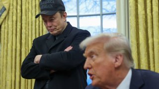 Elon Musk listens to U.S. President Donald Trump speak in the Oval Office of the White House in Washington, D.C., U.S., Feb. 11, 2025. 