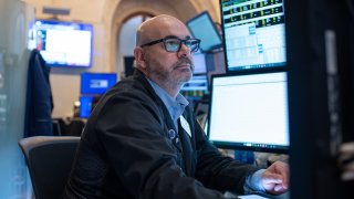 Traders work on the floor of the New York Stock Exchange on Feb. 13, 2025