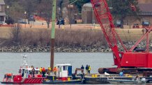 ARLINGTON, VIRGINIA - FEBRUARY 02: A crane moves in to place on the Potomac River for recovery efforts on February 02, 2025 in Arlington, Virginia. An American Airlines flight from Wichita, Kansas collided midair with a military Black Hawk helicopter while on approach to Ronald Reagan Washington National Airport on January 29, 2025 outside of Washington, DC. According to reports, there were no survivors among the 67 people onboard both aircraft. (Photo by Tasos Katopodis/Getty Images)