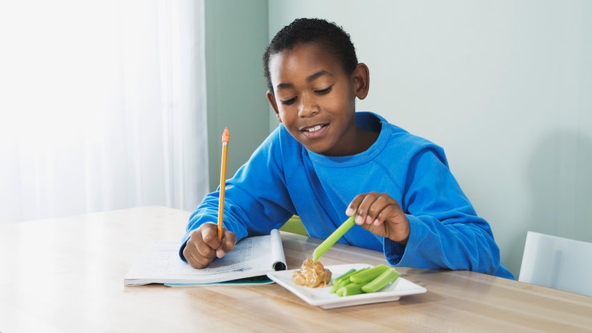 Boy eating peanut butter and celery