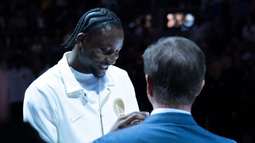October 18, 2022; San Francisco, California, USA; Golden State Warriors forward Jonathan Kuminga (00) receives his championship ring from owner Joe Lacob (right) before the game against the Los Angeles Lakers at Chase Center. Mandatory Credit: Kyle Terada-USA TODAY Sports