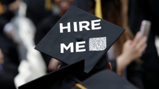 A graduating student of the CCNY wears a message on his cap during the College’s commencement ceremony.