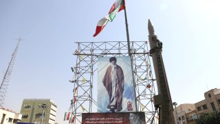 An Iranian missile system is displayed next to a banner with a picture of Iran’s Supreme Leader Ayatollah Ali Khamenei and the late Lebanon’s Hezbollah leader Hassan Nasrallah, in a street in Tehran, Iran, October 2, 2024. 