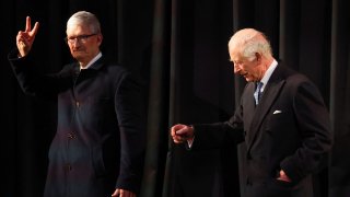 Britain’s King Charles and CEO of Apple, Tim Cook walk at Apple’s UK Head Office at Battersea Power Station in London, Britain, December 12, 2024. 