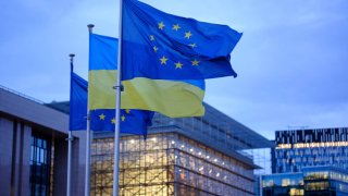 European Union, and Ukrainian flags fly in front of the Berlaymont, the EU Commission headquarters, for the 3rd anniversary of the large scale invasion of Ukraine by Russia on Feb. 24, 2025 in Brussels, Belgium.