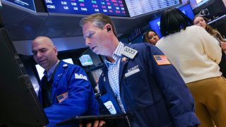 Traders work on the floor of the New York Stock Exchange at the opening bell on March 7, 2025.