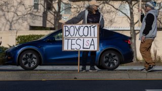 Residents protest against Elon Musk’s role at U.S. President Donald Trump’s administration, outside of a Tesla dealership in Palo Alto, California, U.S. March 5, 2025.