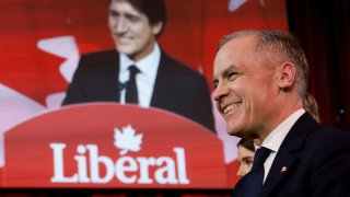 Mark Carney listens as Canadian Prime Minister Justin Trudeau speaks on the day members of Canada’s Liberal Party gather to choose a successor to Trudeau, in Ottawa, Ontario, Canada, March 9, 2025. 