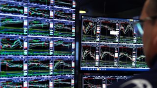 A trader works on the floor of the New York Stock Exchange (NYSE) at the opening bell in New York City on March 10, 2025.