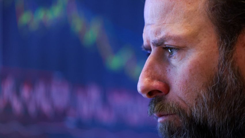 A trader works on the floor of the New York Stock Exchange (NYSE) at the opening bell in New York City on March 10, 2025. 