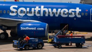 Baggage handlers load luggage onto a Southwest Airlines Boeing 737 at Austin-Bergstrom International Airport on August 24, 2024 in Austin, Texas. 