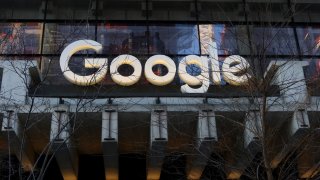 A Google corporate logo hangs above the entrance to their office at St. John’s Terminal on March 11, 2025, in New York City.