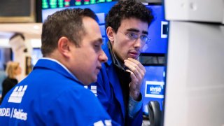 Traders work on the floor of the New York Stock Exchange on March 13, 2025.