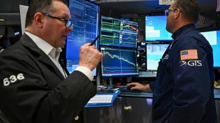 Traders work on the floor of the New York Stock Exchange at the opening bell in the Financial District of New York City on March 17, 2025.