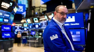 Traders work at the New York Stock Exchange on March 18, 2025.