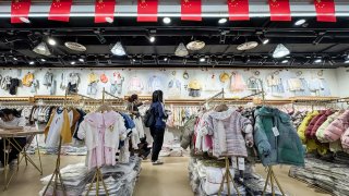 Customers browse children’s clothing at a wholesale store in Chongqing, China, on March 1, 2025.