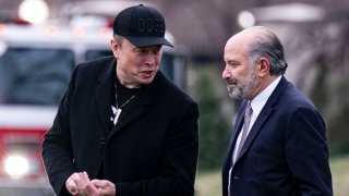 Elon Musk, chief executive officer of Tesla Inc., from left, Howard Lutnick, US commerce secretary, walk on the South Lawn of the White House before boarding Marine One in Washington, DC, US, on Friday, March 14, 2025.