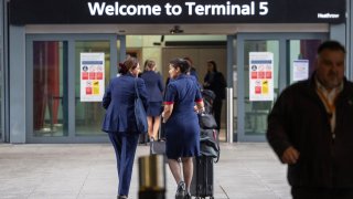 British Airways crew members arrive at terminal 5 at Heathrow on March 21, 2025 in London, England.