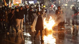 Protesters clash with Turkish anti riot police as they use tear gas and water cannons during a demonstration following the arrest of Istanbul’s mayor, in Ankara on March 21, 2025.